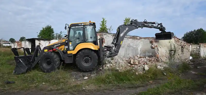 Bagr bourající garáž